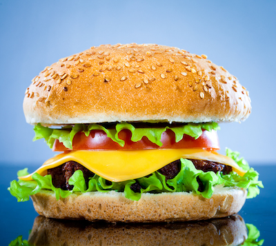 Tasty and appetizing hamburger on a blue background