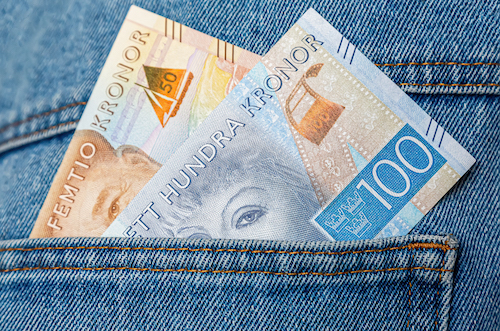 Swedish kronor banknotes sticking out of the blue jeans pocket