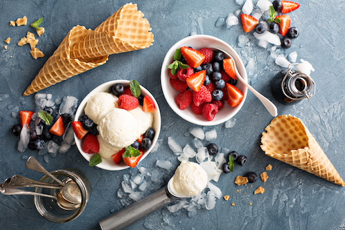 Vanilla ice cream scoops with fresh berries overhead shot