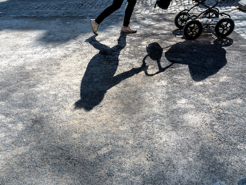 shadow eirn woman with a stroller.